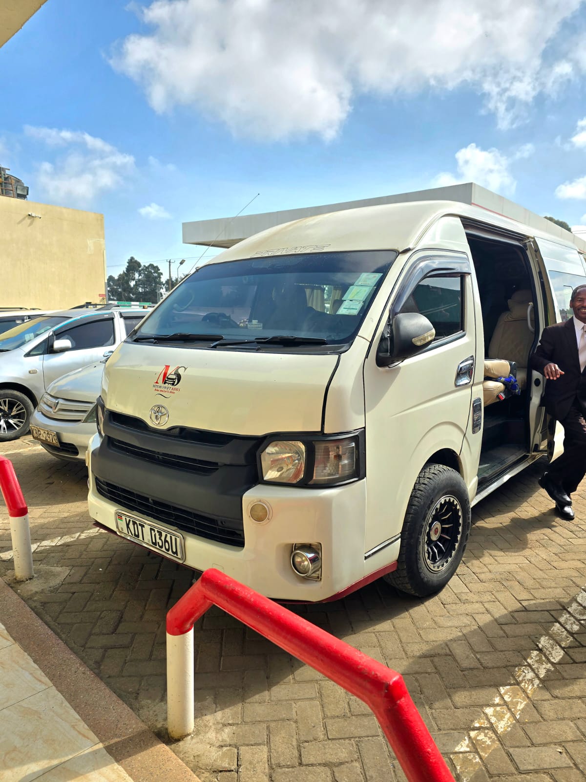 Mtemi Swift Rides van with a passenger stepping out, ready for event transport