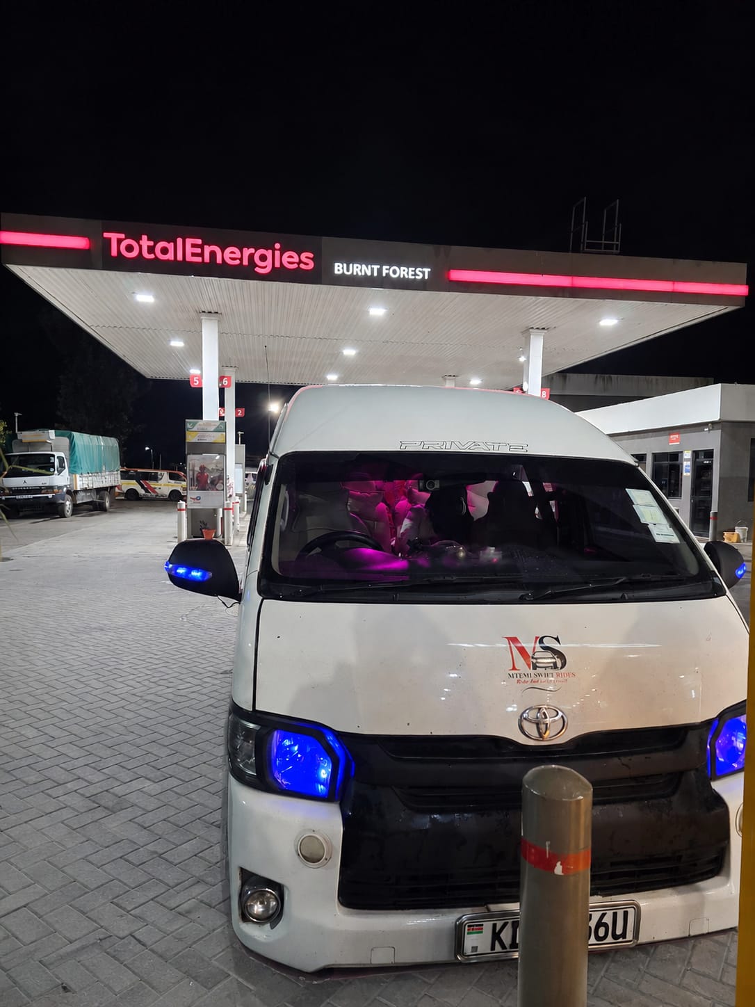 Mtemi Swift Rides van at a fuel stop during an evening journey